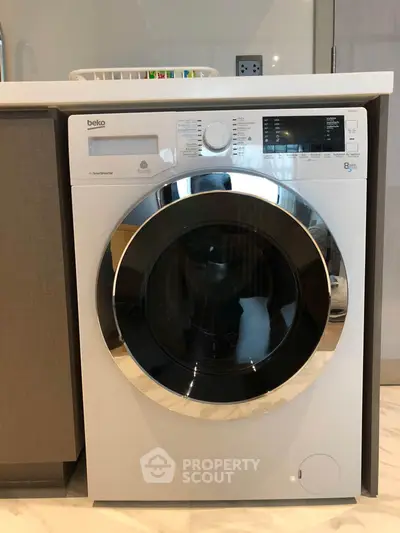 Modern washing machine in sleek kitchen setting, perfect for contemporary homes.
