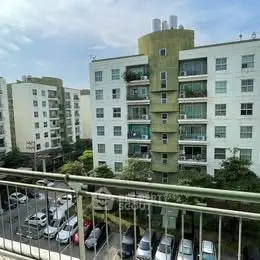 Modern apartment building with parking view, showcasing urban living convenience.