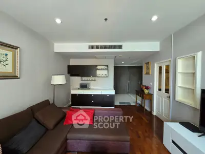 Modern living room with stylish furniture and open kitchen layout in a cozy apartment.