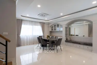 Elegant dining area with modern furniture and large windows in a spacious living room