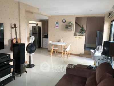 Cozy living room with modern decor, featuring a dining area and musical instruments, perfect for relaxation.