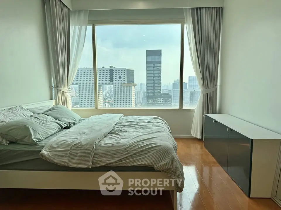 Spacious bedroom with stunning city view and modern furnishings