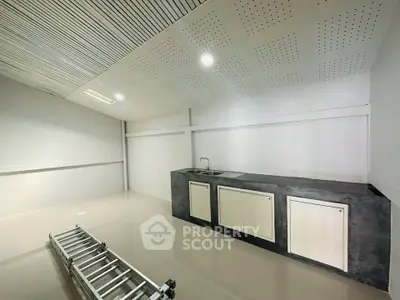 Spacious modern storage room with sleek cabinetry and ample lighting.