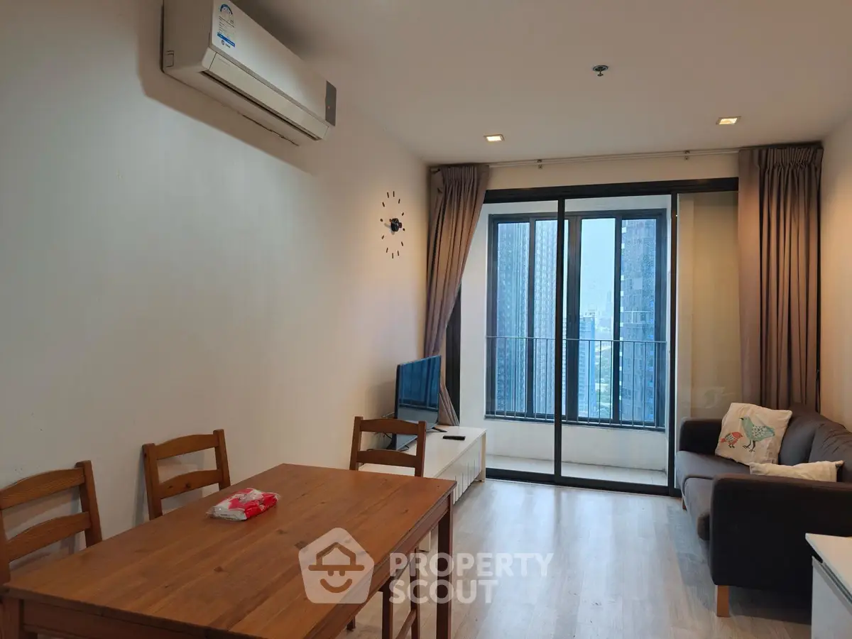 Modern living room with balcony view in high-rise apartment