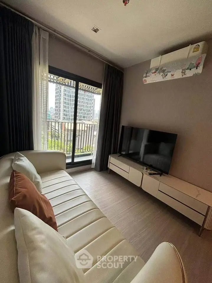 Modern living room with sleek furniture and city view balcony