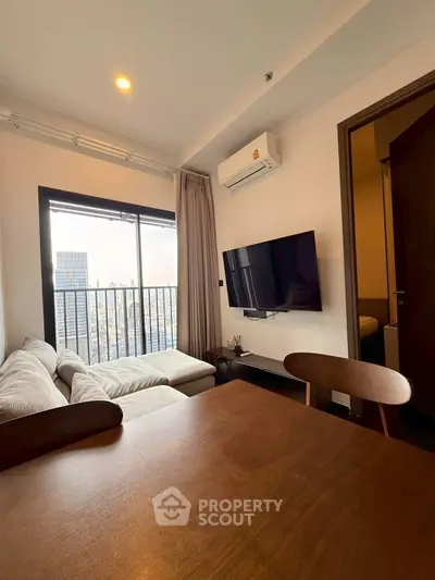 Modern living room with city view, featuring cozy sofa and wall-mounted TV.