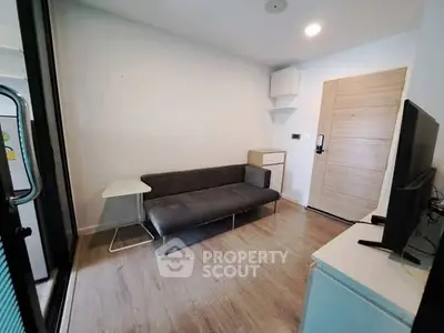 Modern living room with sleek furniture and wooden flooring in a stylish apartment.