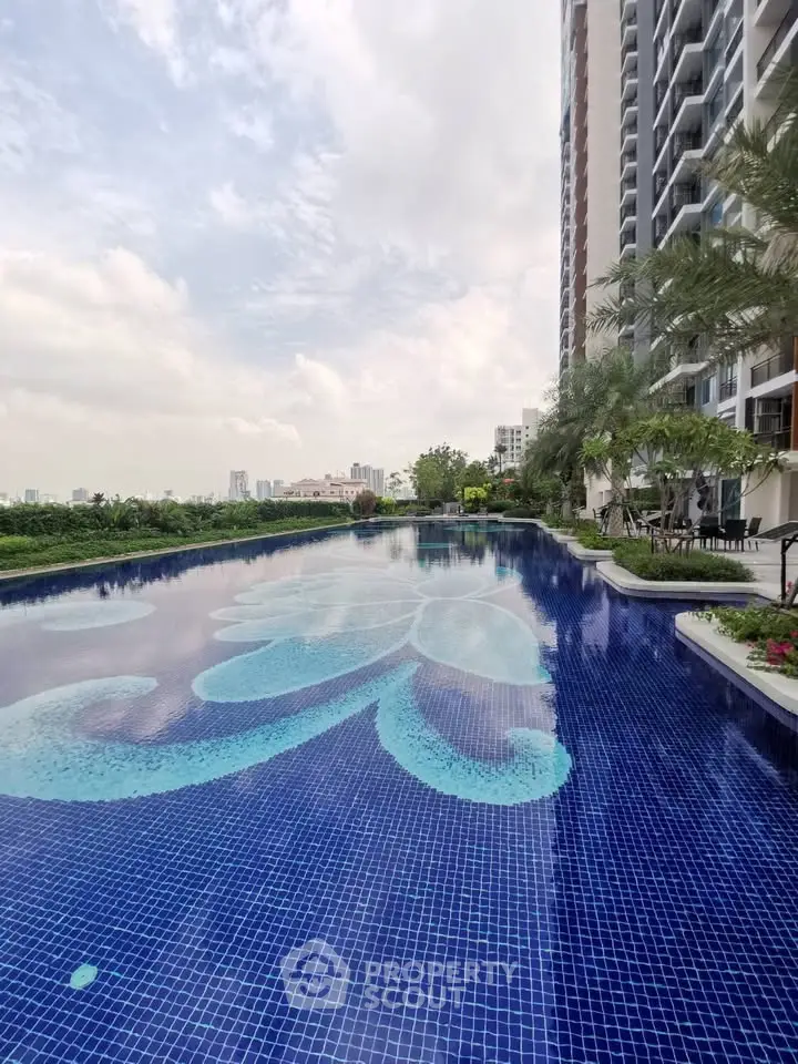 Luxurious residential pool with stunning cityscape views and modern high-rise building.