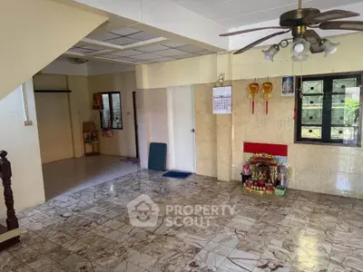 Spacious living room with tiled flooring and ceiling fan in a cozy home