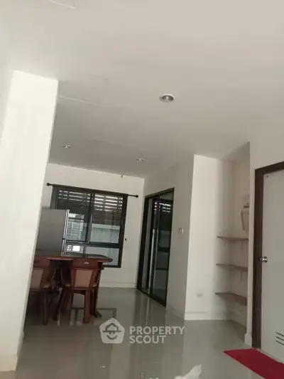 Spacious modern dining area with sleek furniture and large windows for natural light.
