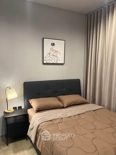 Cozy bedroom with elegant decor and modern furnishings, featuring a plush bed and stylish artwork.
