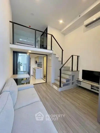 Modern loft apartment with mezzanine, sleek staircase, and open living area, perfect for urban living.