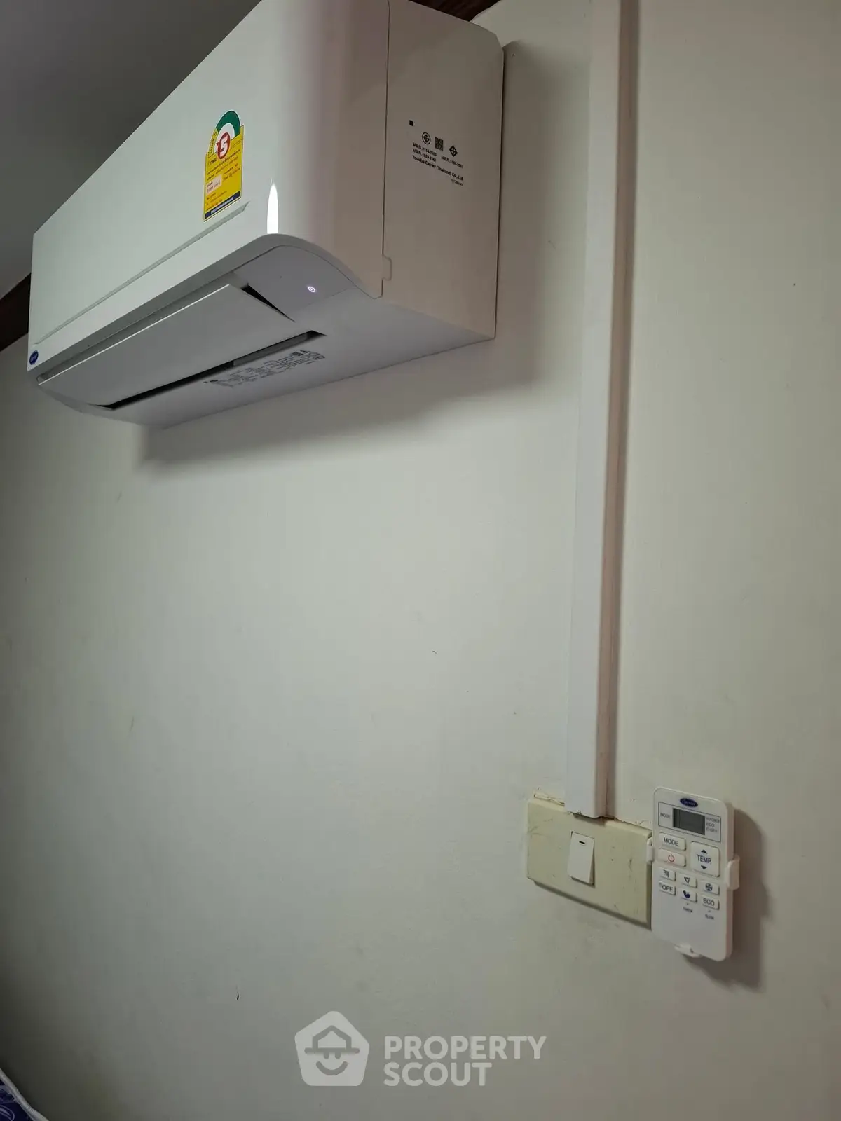 Modern wall-mounted air conditioning unit in a residential interior setting.
