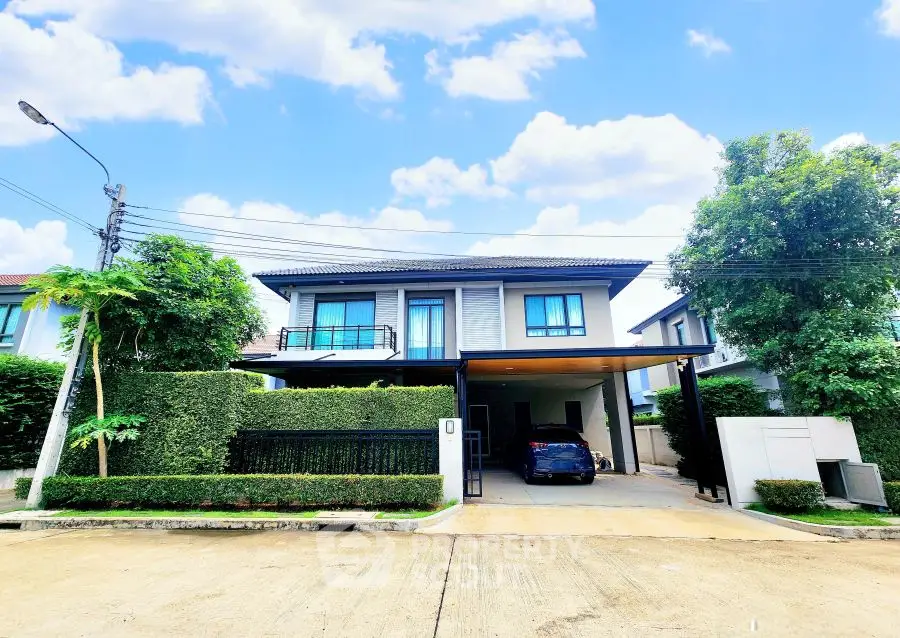 Modern two-story house with lush greenery and spacious driveway