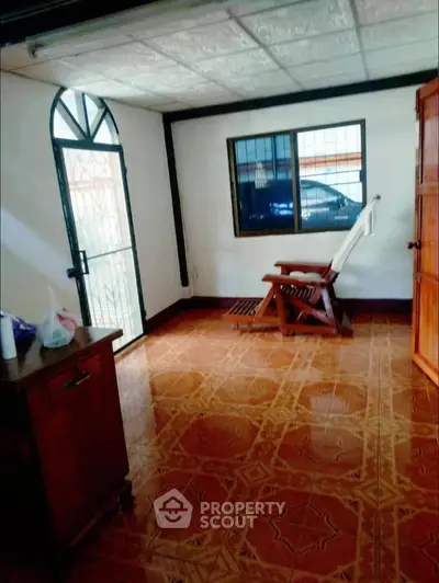 Cozy interior room with wooden furniture and decorative tile flooring.