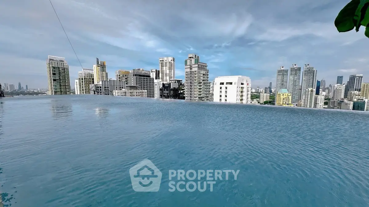 Stunning rooftop infinity pool with breathtaking city skyline view