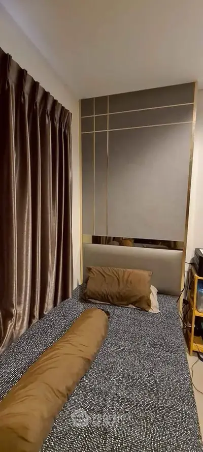 Cozy bedroom with elegant curtains and modern decor, perfect for a restful retreat.