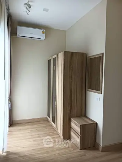 Modern bedroom with wooden wardrobe and air conditioning unit