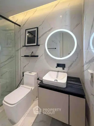 Luxurious modern bathroom with elegant marble tiles and illuminated mirror