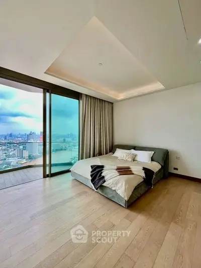 Luxurious bedroom with stunning city view and spacious balcony access