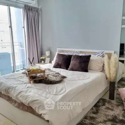 Cozy bedroom with balcony access and stylish decor