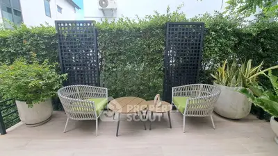 Charming garden patio with stylish seating and lush greenery