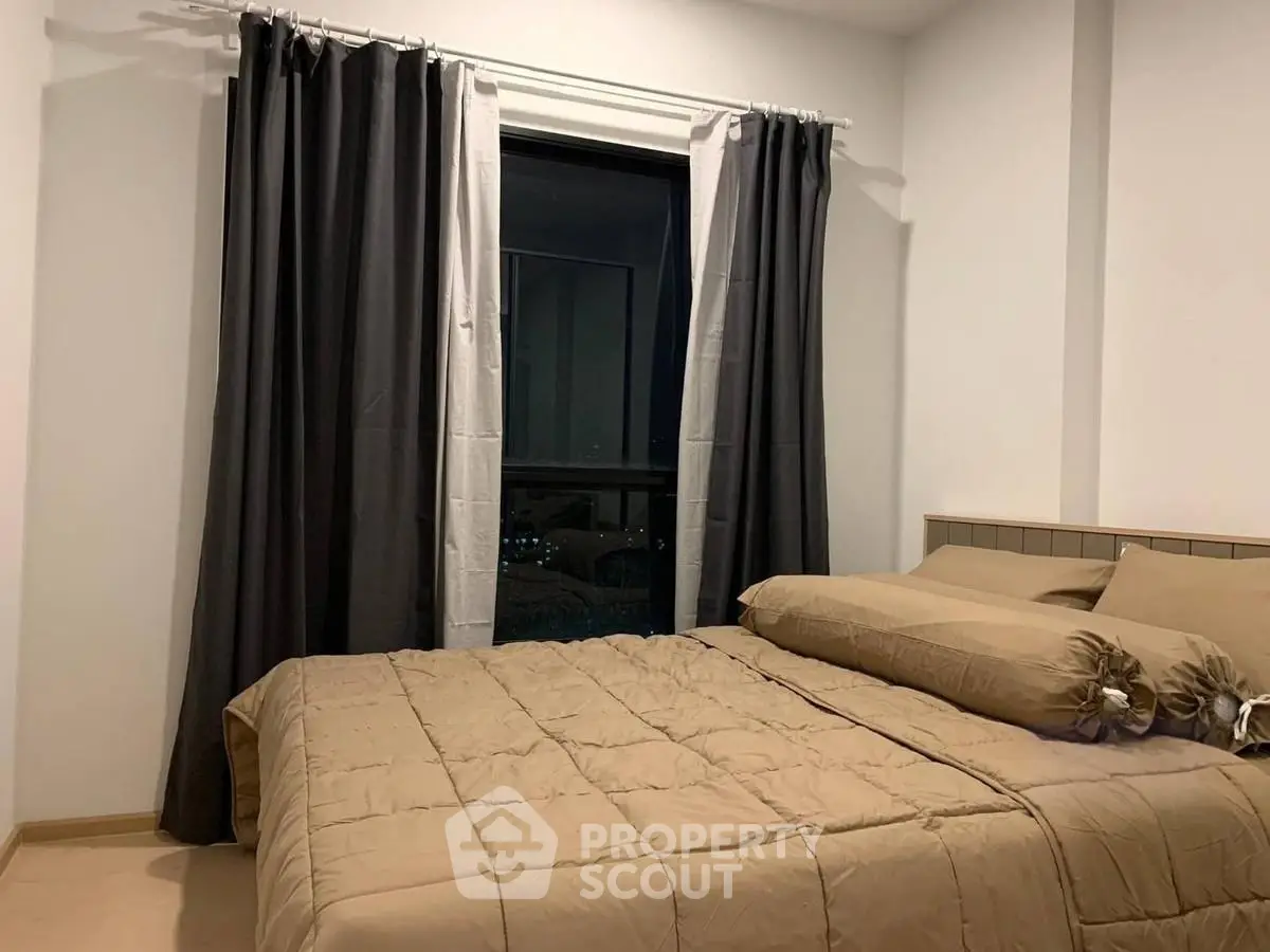 Cozy bedroom with elegant curtains and plush bedding for a restful retreat.