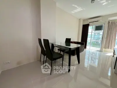 Modern living room with glass dining table and natural light