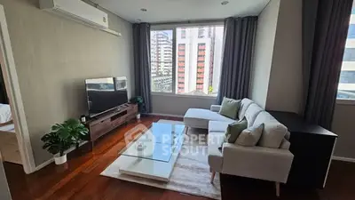Modern living room with large window and stylish furniture in urban apartment