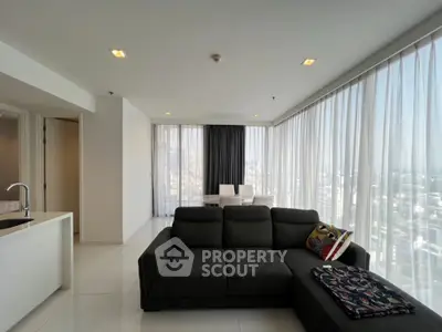 Spacious modern living room with panoramic city views and elegant decor