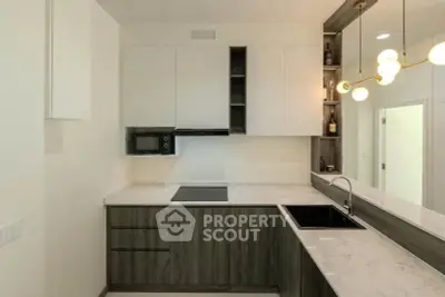 Modern kitchen with sleek cabinetry and stylish lighting
