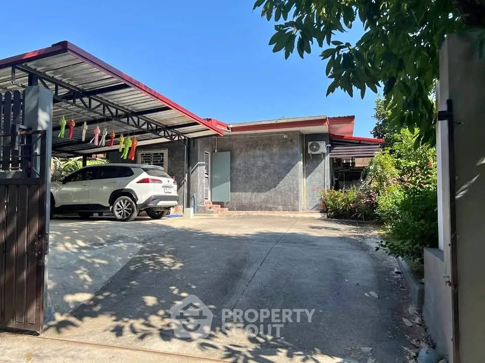 Charming single-story home with carport and lush garden, perfect for serene living.