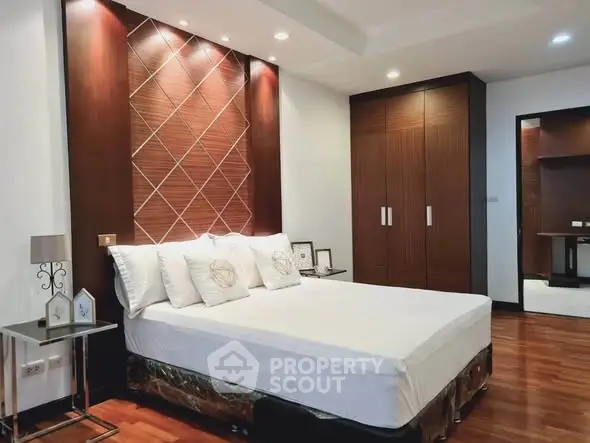Luxurious bedroom with elegant wood paneling and modern decor