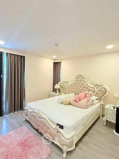 Luxurious bedroom with elegant furniture and plush decor in a modern apartment.