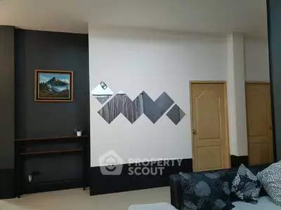 Modern living room with stylish wall art and cozy sofa in a contemporary home.
