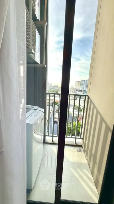 Charming balcony with city view and washing machine, perfect for urban living.