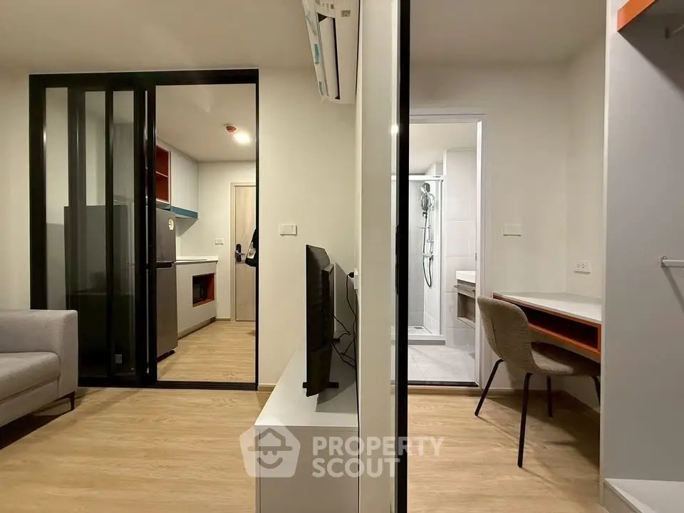 Modern apartment interior with open layout, featuring a cozy living area, sleek kitchen, and stylish bathroom.