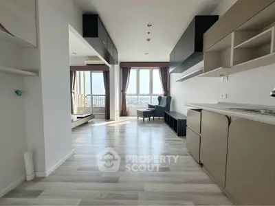 Spacious modern living room with open kitchen and stunning city view