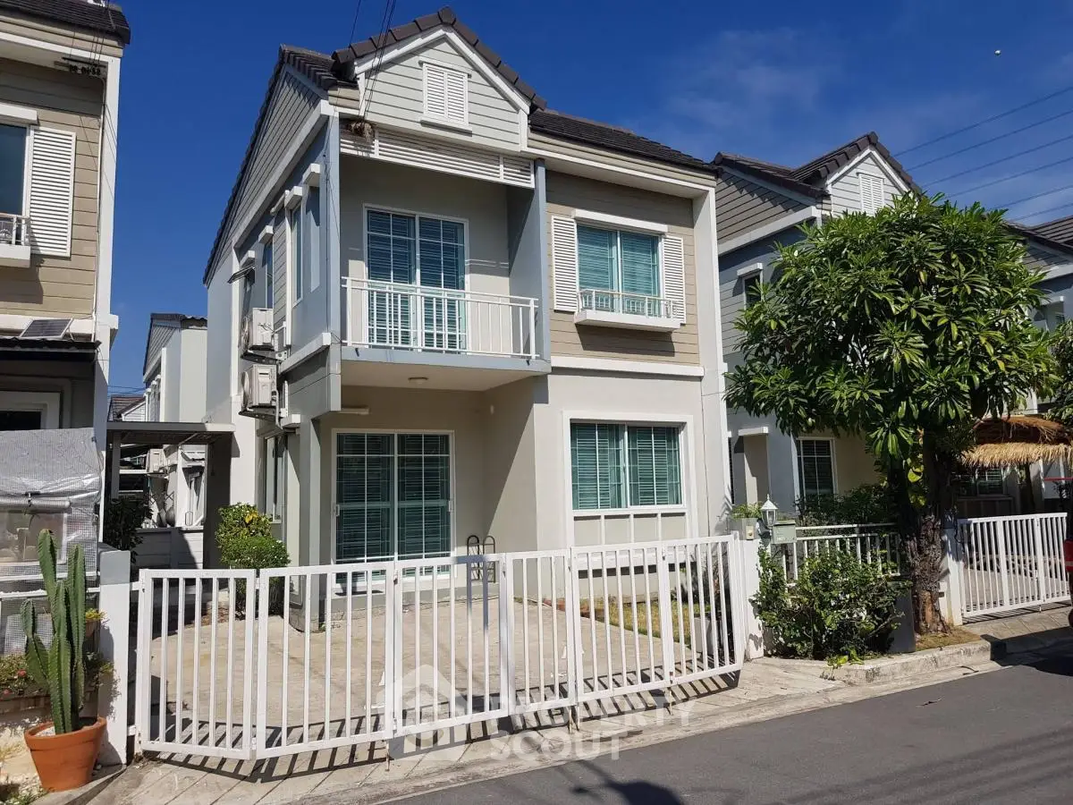 Charming two-story house with modern design and spacious driveway in a serene neighborhood.