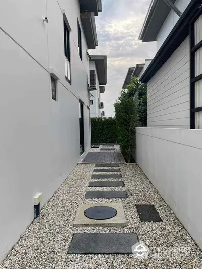 Modern exterior pathway with sleek design and pebble landscaping