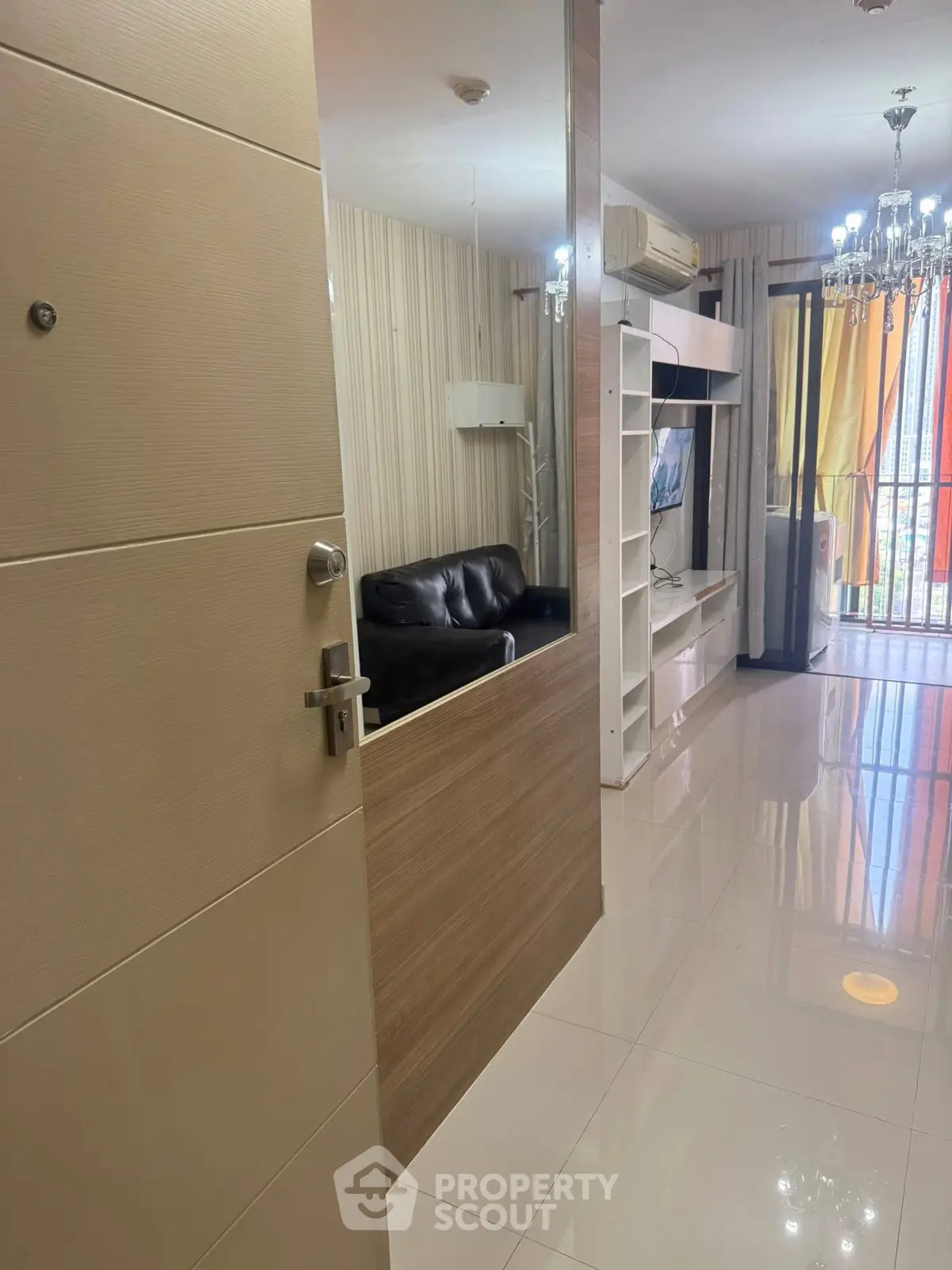 Modern living room with sleek design and balcony view, featuring elegant lighting and contemporary furniture.