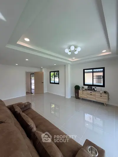 Spacious modern living room with elegant lighting and large windows