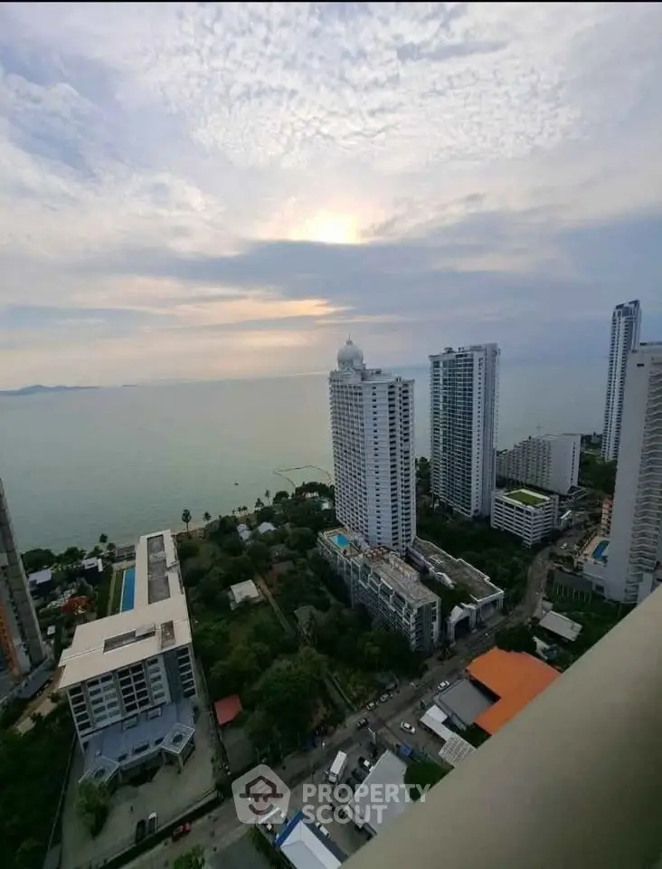 Stunning ocean view from high-rise balcony overlooking city skyline and waterfront.
