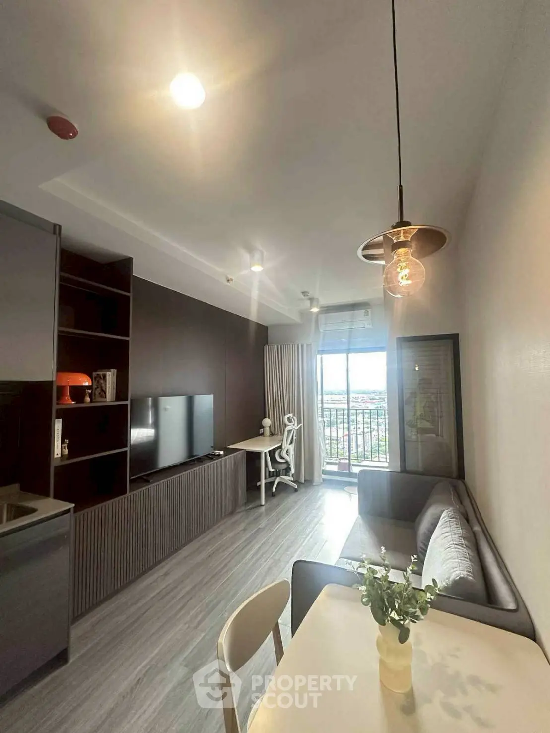 Modern living room with stylish decor and balcony view