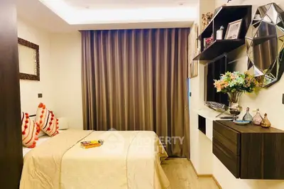 Cozy bedroom with elegant decor and modern shelving, featuring a comfortable bed and stylish curtains.