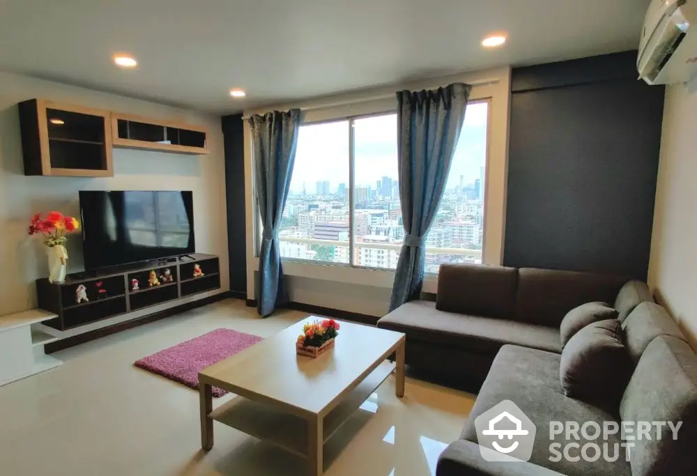 Spacious living room with city view, modern furniture, and large window for natural light.