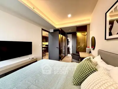 Modern bedroom with stylish decor and open layout leading to kitchen area.