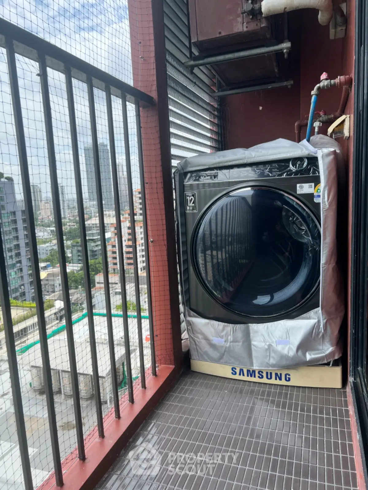 Modern balcony with city view featuring a Samsung washing machine, perfect for urban living convenience.