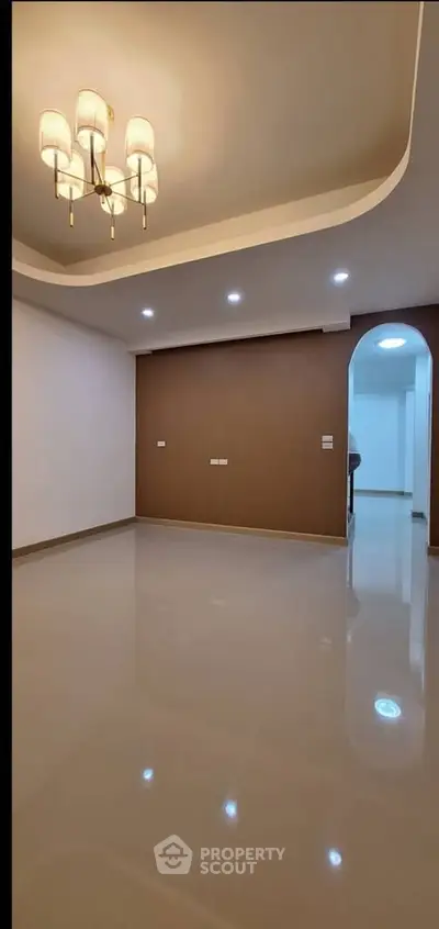 Spacious empty living room with elegant lighting and glossy floors