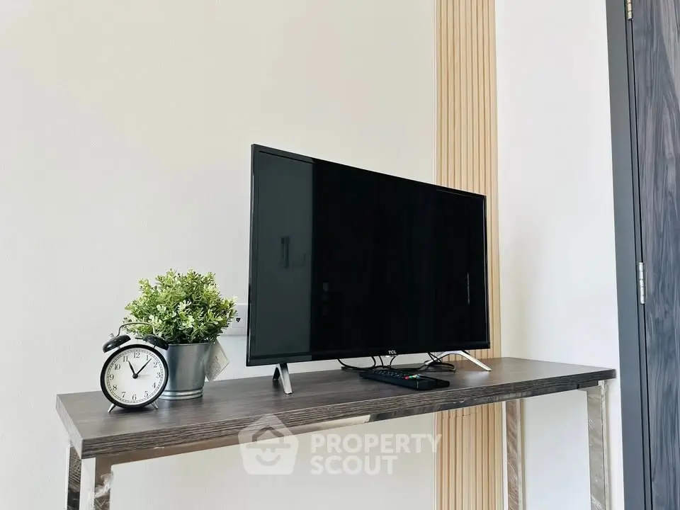 Modern interior with sleek TV setup on stylish console table, perfect for contemporary living spaces.